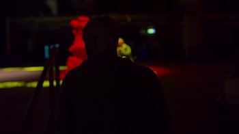 Movie still from “Bill Burr: Live at Red Rocks” (2022), directed by Mike Binder – A man standing in a dark room at night; Close Up shot, Low angle