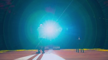 Movie still from “Bill Burr: Live at Red Rocks” (2022), directed by Mike Binder – A person standing on a stage with a light shining in the background; Extreme Wide shot, Low angle
