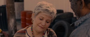 Movie still from “Bingo Hell” (2021), directed by Gigi Saul Guerrero – An older woman with short grey hair is looking down at her face; Close Up shot, Over the shoulder angle