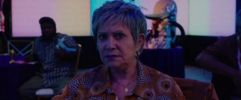 Movie still from “Bingo Hell” (2021), directed by Gigi Saul Guerrero – An older woman with short grey hair looking at the camera; Close Up shot, Over the shoulder angle