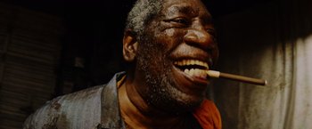 An older man with a cigarette in his mouth