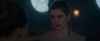 Movie still from “Birds of Paradise” (2021), directed by Sarah Adina Smith – A woman is looking at the camera in the dark; Close Up shot, Over the shoulder angle