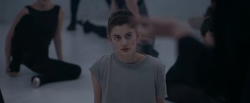 Movie still from “Birds of Paradise” (2021), directed by Sarah Adina Smith – A woman in a gray shirt is looking at the camera; Close Up shot, Over the shoulder angle