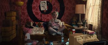 Movie still from “Birds of Prey” (2020), directed by Cathy Yan – A woman sitting on a couch eating a bowl of cereal; Wide shot, High angle