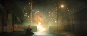 Movie still from “Birds of Prey” (2020), directed by Cathy Yan – A person sitting on the ground in front of a fire; Extreme Wide shot, High angle