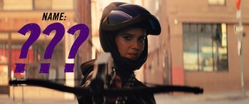 Movie still from “Birds of Prey” (2020), directed by Cathy Yan – A woman in a motorcycle helmet is holding a gun; Close Up shot, Over the shoulder angle