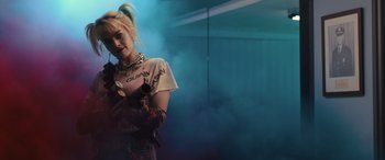 Movie still from “Birds of Prey” (2020), directed by Cathy Yan – A woman in a harley quinn costume standing in a room; Medium shot, Low angle