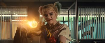 Movie still from “Birds of Prey” (2020), directed by Cathy Yan – A woman with blonde hair is holding a gun; Close Up shot, Low angle