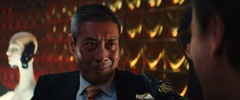 Movie still from “Birds of Prey” (2020), directed by Cathy Yan – A person wearing a suit and tie; Close Up shot, Low angle