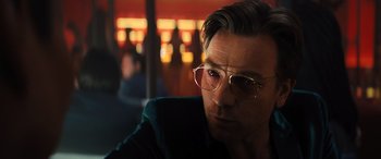 Movie still from “Birds of Prey” (2020), directed by Cathy Yan – A person wearing glasses; Close Up shot, Over the shoulder angle