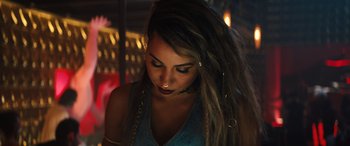 Movie still from “Birds of Prey” (2020), directed by Cathy Yan – A woman with dreadlocks is looking down at her face; Close Up shot, High angle