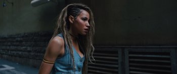 Movie still from “Birds of Prey” (2020), directed by Cathy Yan – A woman with dreadlocks is looking to her left; Close Up shot, Over the shoulder angle