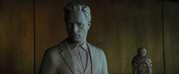 Movie still from “Birds of Prey” (2020), directed by Cathy Yan – A statue of a man wearing a suit and tie; Close Up shot, High angle