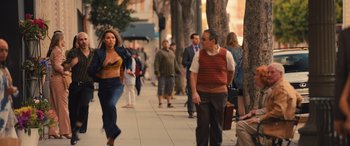 Movie still from “Birds of Prey” (2020), directed by Cathy Yan – A group of people walking down a sidewalk; Wide shot, Over the shoulder angle