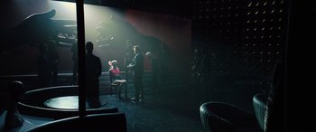 Movie still from “Birds of Prey” (2020), directed by Cathy Yan – A group of people standing in a dark room; Wide shot, Over the shoulder angle