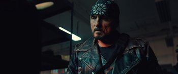 Movie still from “Birds of Prey” (2020), directed by Cathy Yan – A man wearing a leather jacket and a bandana; Close Up shot, Over the shoulder angle