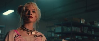 Movie still from “Birds of Prey” (2020), directed by Cathy Yan – A woman with blonde hair wearing a white shirt; Close Up shot, Low angle