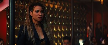 Movie still from “Birds of Prey” (2020), directed by Cathy Yan – A woman with long dreadlocks standing in front of a wall; Close Up shot, Over the shoulder angle