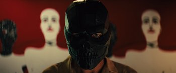 Movie still from “Birds of Prey” (2020), directed by Cathy Yan – A man wearing a black mask with a skull on it's face; Close Up shot, Low angle