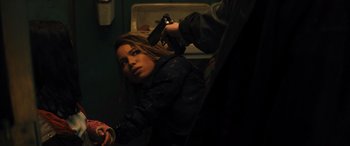 Movie still from “Birds of Prey” (2020), directed by Cathy Yan – A woman with a gun in her hand and a man with a gun in her other hand; Close Up shot, Over the shoulder angle