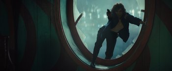 Movie still from “Birds of Prey” (2020), directed by Cathy Yan – A woman holding a gun in front of a mirror; Wide shot, High angle