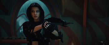 Movie still from “Birds of Prey” (2020), directed by Cathy Yan – A woman holding a gun while wearing a black outfit; Medium shot, Low angle