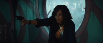 Movie still from “Birds of Prey” (2020), directed by Cathy Yan – A woman is pointing at something in the dark; Medium shot, High angle