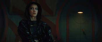 Movie still from “Birds of Prey” (2020), directed by Cathy Yan – A woman wearing a black jacket and a black hood; Close Up shot, Low angle