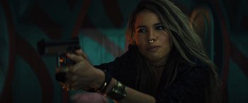 Movie still from “Birds of Prey” (2020), directed by Cathy Yan – A woman is holding a cell phone up to her face; Close Up shot, Over the shoulder angle