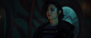 Movie still from “Birds of Prey” (2020), directed by Cathy Yan – A woman in a dark room looking to her left; Close Up shot, Over the shoulder angle