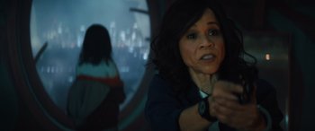 Movie still from “Birds of Prey” (2020), directed by Cathy Yan – A woman in a dark room holding a remote control; Close Up shot, Over the shoulder angle