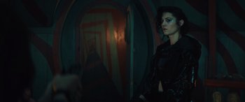 Movie still from “Birds of Prey” (2020), directed by Cathy Yan – A woman standing in a dark room holding a gun; Medium shot, Low angle