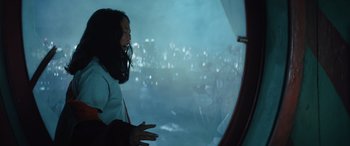 Movie still from “Birds of Prey” (2020), directed by Cathy Yan – A woman looking out of a window at night; Medium shot, Over the shoulder angle