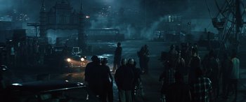Movie still from “Birds of Prey” (2020), directed by Cathy Yan – A group of people standing in the middle of a street; Extreme Wide shot, High angle