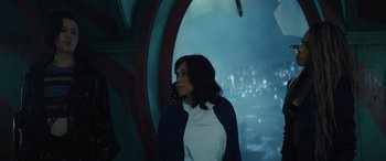 Movie still from “Birds of Prey” (2020), directed by Cathy Yan – A woman standing in front of a window with a city in the background; Medium shot, High angle