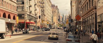 Movie still from “Birds of Prey” (2020), directed by Cathy Yan – A car driving down a street next to tall buildings; Extreme Wide shot, High angle