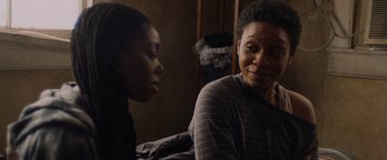 Movie still from “Black as Night” (2021), directed by Maritte Lee Go – Two women sitting on a bed talking to each other; Close Up shot, Over the shoulder angle