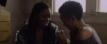 Movie still from “Black as Night” (2021), directed by Maritte Lee Go – A woman and a man sitting next to each other; Close Up shot, Over the shoulder angle