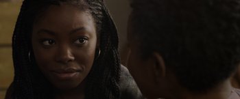Movie still from “Black as Night” (2021), directed by Maritte Lee Go – A woman with braids is looking at a man; Close Up shot, Over the shoulder angle