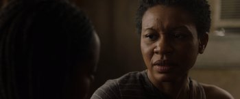 Movie still from “Black as Night” (2021), directed by Maritte Lee Go – An older woman sitting in front of a younger man; Close Up shot, Over the shoulder angle