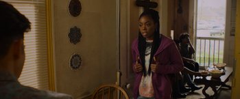 Movie still from “Black as Night” (2021), directed by Maritte Lee Go – A young girl with long braids standing in front of a mirror; Medium shot, Over the shoulder angle