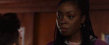 Movie still from “Black as Night” (2021), directed by Maritte Lee Go – A person with long braids; Close Up shot, Over the shoulder angle