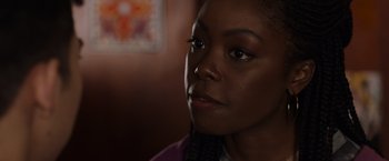 Movie still from “Black as Night” (2021), directed by Maritte Lee Go – A person's face in a dark room; Close Up shot, Over the shoulder angle
