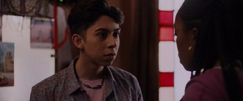 Movie still from “Black as Night” (2021), directed by Maritte Lee Go – A young man is looking into the distance; Close Up shot, Over the shoulder angle