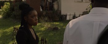 Movie still from “Black as Night” (2021), directed by Maritte Lee Go – A woman standing next to a man in front of a house; Close Up shot, Over the shoulder angle