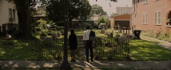Movie still from “Black as Night” (2021), directed by Maritte Lee Go – A man and a woman standing in front of a cemetery; Extreme Wide shot, High angle