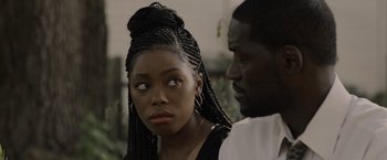 Movie still from “Black as Night” (2021), directed by Maritte Lee Go – A man and a woman standing next to each other; Close Up shot, Over the shoulder angle