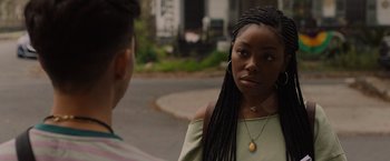 Movie still from “Black as Night” (2021), directed by Maritte Lee Go – A woman standing next to a man on the side of the road; Close Up shot, Over the shoulder angle