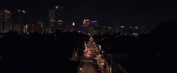 Movie still from “Black as Night” (2021), directed by Maritte Lee Go – A city street at night lit up by street lights; Extreme Wide shot, Low angle