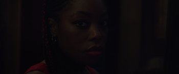 Movie still from “Black as Night” (2021), directed by Maritte Lee Go – A woman's face in the dark; Close Up shot, Over the shoulder angle